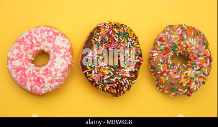 Sprinkle Donuts on a Yellow Background Stock Photo