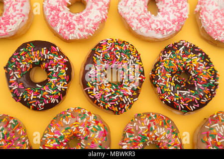 Sprinkle Donuts on a Yellow Background Stock Photo
