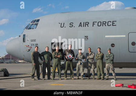Members of the C-130J Super Hercules number 5692 delivery team pose for a photo, Jan. 10, 2018, at Yokota Air Base, Japan. This was the tenth C-130J delivered to Yokota as part of a fleet-wide redistribution of assets set in motion by Air Mobility Command; this aircraft came from Dyess Air Force Base, Texas. (U.S. Air Force photo by Yasuo Osakabe) Stock Photo