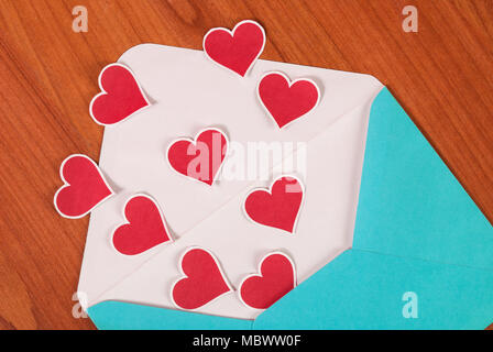 Love red hearts and blue letter on wood desk background Stock Photo