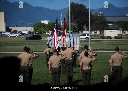 U.S. Marines with the ceremonial staff of the Headquarters Battalion, Marine Corps Base Hawaii relief and appointment ceremony salute the colors, Jan. 12, 2018. Sgt. Maj. Robert C. Ixtlahuac relieved Sgt. Maj. Phillip J. Billiot as the sergeant major for Headquarters Battalion, Marine Corps Base Hawaii. (U.S. Marine Corps photo by Sgt. Alex Kouns) Stock Photo