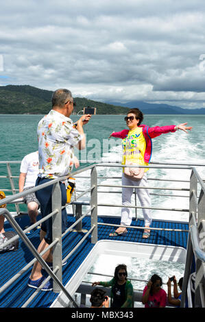 A couple of Chinese tourists taking a portrait while cruising at the Great Barrier Reef, Far North Queensland, QLD, FNQ, Australia Stock Photo
