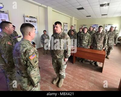 YAVORIV, UKRAINE -- Joint Multinational Training Group - Ukraine - Newly promoted 1st. Lt. Christopher McKay of Delta Company (FSC) is called upon to receive his promotion by the Battalion Commander Lt. Col. William Murphy on 16 January 2018. Stock Photo