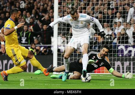 Madrid, Spain. 11th Apr, 2018. Juventus' goalkeeper Gianluigi Buffon (R) defends against Real Madrid's Gareth Bale (C) during the UEFA Champions League quarterfinal second leg soccer match between Spanish team Real Madrid and Italian team Juventus in Madrid, Spain, on April 11, 2018. Juventus won 3-1. Real Madrid advanced to the semifinal with 4-3 on aggregate. Credit: Edward Peters Lopez/Xinhua/Alamy Live News Stock Photo