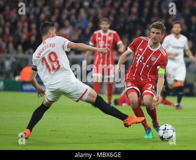 Munich, Germany. 11th Apr, 2018. Bayern Munich's Thomas Mueller (R) vies with Sevilla's Sergio Escudero during the UEFA Champions League quarterfinal second leg soccer match between Bayern Munich of Germany and FC Sevilla of Spain in Munich, Germany, on April 11, 2018. The match ended 0-0 and Bayern Munich advanced to the semifinal with 2-1 on aggregate. Credit: Philippe Ruiz/Xinhua/Alamy Live News Stock Photo