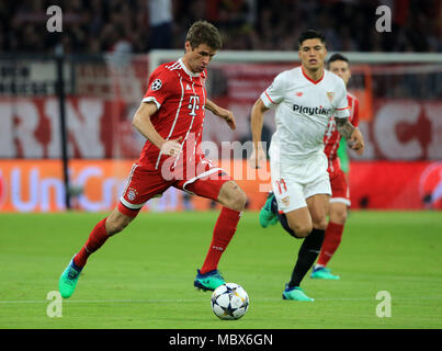 Munich, Germany. 11th Apr, 2018. Bayern Munich's Thomas Mueller (L) competes during the UEFA Champions League quarterfinal second leg soccer match between Bayern Munich of Germany and FC Sevilla of Spain in Munich, Germany, on April 11, 2018. The match ended 0-0 and Bayern Munich advanced to the semifinal with 2-1 on aggregate. Credit: Philippe Ruiz/Xinhua/Alamy Live News Stock Photo