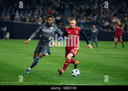 Bronx, New York, USA. 11th April, 2018. Albert Rusnák (11) of Real Salt Lake shields the ball from NYCFC's Sebastien Ibeagha (33) during the second half of RSL's 4-0 loss to NYCFC. Stock Photo