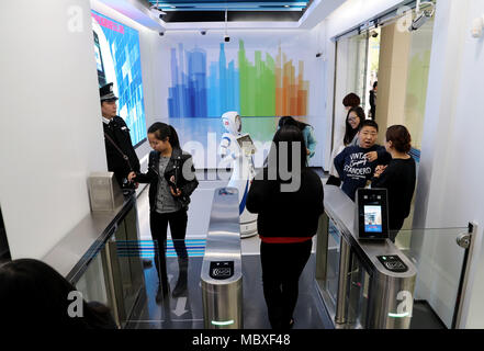 Shanghai, China. 12th Apr, 2018. A customer enters a self-service area of Jiujiang Road branch of China Construction Bank (CCB) in Shanghai, east China, April 12, 2018. Customers are able to transact 90 percent of cash and non-cash business in the self-service area of the branch. Credit: Fang Zhe/Xinhua/Alamy Live News Stock Photo