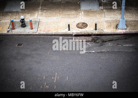New York City, Manhattan street scene viewed from above with sidewalk, fire hydrant and manhole drainage seen from Chelsea. Stock Photo