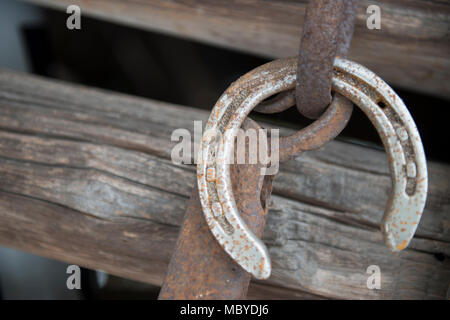 Old lucky horse shoe on wood fence shoe came off Stock Photo