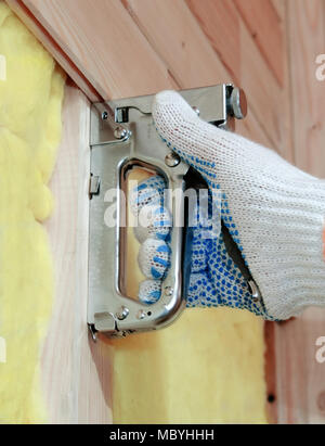 Fastening of wooden laths by means of brackets and a stapler Stock Photo