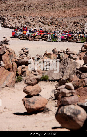 Peruvian Women selling traditional Textiles on Top of a high Mountain Pass in the Andes Stock Photo