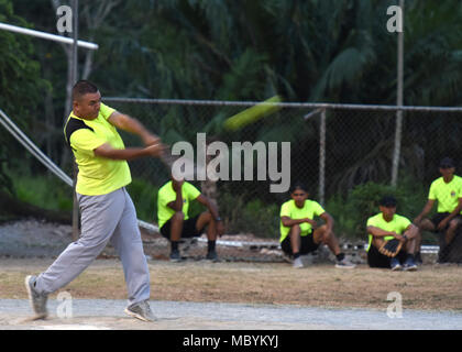 A member of the Panamanian military and police force known as SENAFRONT hits a softball during a game with U.S. military members of the 346th Air Expeditionary Group participating in Exercise New Horizons 2018 April 1, 2018, in Meteti, Panama. During the exercise, aimed at training U.S. military members and assisting partner nations, exercise personnel also spend down time playing sports, participating in local events and interacting with locals to build relationships and promote U.S. and Panamanian partnership. Exercise New Horizons is a joint training exercise where all branches of the U.S.  Stock Photo