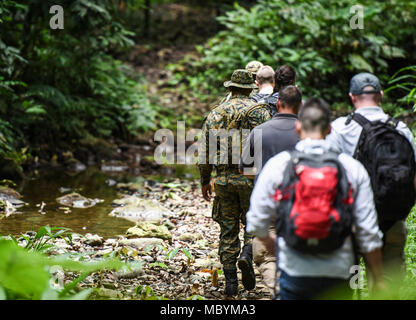 Members of the 346th Air Expeditionary Group hike along a trail in the Darien National Park, Panama, April 2, 2018, during exercise New Horizons 2018. Following the hike, 346th AEG members spoke to local village members about the assistance that New Horizons 2018 will bring to the communities throughout the region. Exercise New Horizons is a joint training exercise where all branches of the U.S. military conduct training in civil engineer, medical and support services while benefiting the local community. Stock Photo