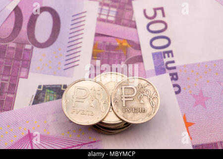 ruble coins and the symbol of the ruble and the numbers on Euro notes Stock Photo