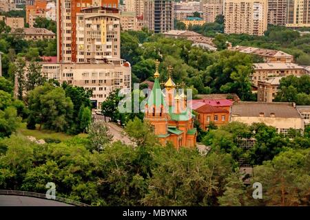 city view from above with green parks and brick buildings with the blue sky on the background Stock Photo