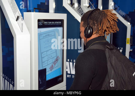 WACO, Texas – (April 4, 2018) Joshua Walker, a senior attending University High School, begins a mission briefing of the Navy’s Virtual Reality Experience, the “Nimitz”, at the school during Waco Navy Week.  The experience consisted of students going through a series of exercises, starting with a briefing, before participating in a virtual high-speed water extraction of a Navy SEAL team pinned down under enemy fire.  Navy Week brings Sailors from different units across the United States to conduct focused outreach events with members of the community in conjunction with the Heart of Texas Airs Stock Photo