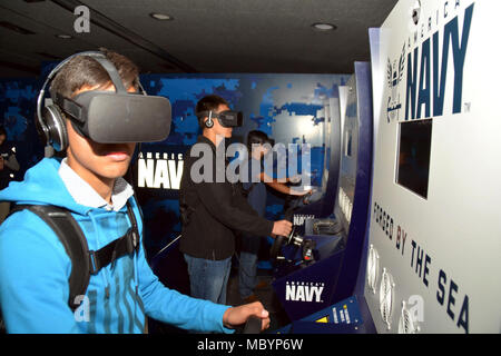 WACO, Texas – (April 4, 2018) Students attending University High School had the opportunity to experience the Navy’s Virtual Reality asset, the “Nimitz”, at the school during Waco Navy Week.  The experience consisted of students going through a series of exercises, starting with a briefing, before participating in a virtual high-speed water extraction of a Navy SEAL team pinned down under enemy fire.  Navy Week brings Sailors from different units across the United States to conduct focused outreach events with members of the community in conjunction with the Heart of Texas Airshow featuring th Stock Photo