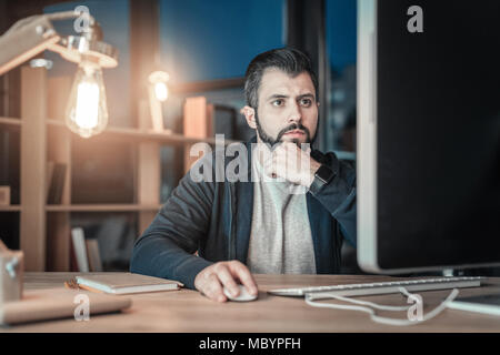 Pensive IT guy facing problem Stock Photo