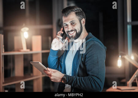 Nice IT guy answering call Stock Photo