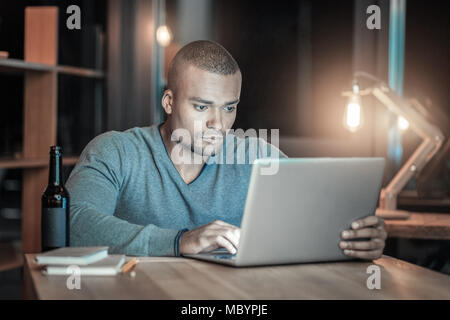 Handsome IT guy testing new laptop Stock Photo