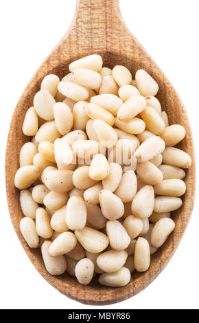 Pine nuts in the wooden spoon. White background. Stock Photo