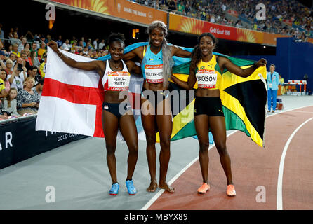 Bahamas' Shaunae Miller-Uibo (centre), Jamaica's Shericka Jackson (right) and England's Dina Asher-Smith (left) celebrate winning gold, silver and bronze respectively in the Women's 200m Final at the Carrara Stadium during day eight of the 2018 Commonwealth Games in the Gold Coast, Australia. Stock Photo