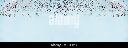 Star shaped silver sequins over blue background banner. Copy space. Stock Photo