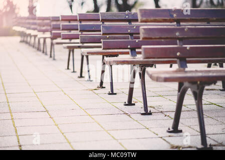 Empty park benches rows in front of an open air stage. Bulgaria, Bourgas, Sea Garden. Stock Photo