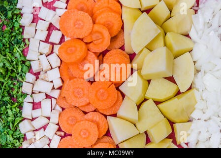 Top view of various vegatables cutted in small pieces prepared for veggie soup cooking. Stock Photo
