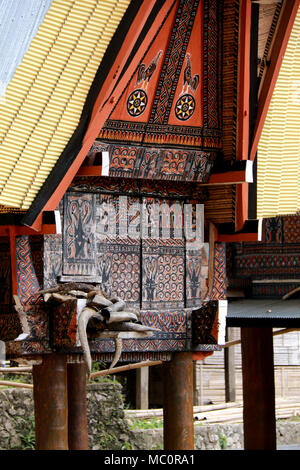 A Tongkonan, a traditional Toraja house with a massive peaked-roof, in a Village near Ke’te’ Ke’su, Toraja, Sulawesi, Indonesia Stock Photo