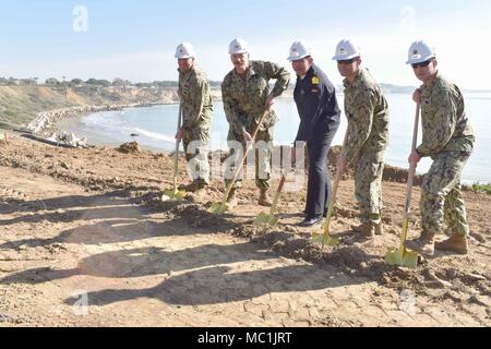 180119-N-VV353-109 NAVAL STATION ROTA, Spain (Jan. 19, 2018)- Commanding officers from Naval Station Rota, Spanish Armada, Naval Mobile Construction Battalion 133, Commander, Task Force 68 and Public Works pose for a group photo during groundbreaking ceremony at the Cliff Erosion Repair project site Jan. 19, 2018. The Cliff Erosion Repair project is a multiyear effort to stabilize 950 meters of shoreline encompassing the Naval Station Rota’s base housing area as a permanent solution to cliff erosion. (U.S. Navy photo by Mass Communication Specialist 3rd Class M. Jang) Stock Photo