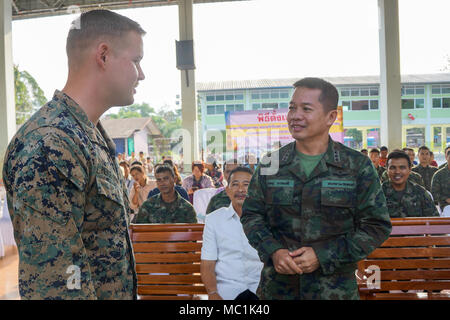 Royal Thai Marine Col. Surachet Thawornkhajornsiri speaks with U.S. Marine 2nd Lt. Daniel Pierce-Parra before a pillar raising ceremony in support of Exercise Cobra Gold 2018 at Wat Khlong Plu School in Chanthaburi Province, Kingdom of Thailand, Jan. 24, 2018. Pierce-Parra is a platoon commander with Marine Wing Support Squadron 171, and is a native of Bellview, Nebraska. The ceremony marked the official start of engineering civic assistance projects for the exercise. (U.S. Marine Corps photo by Capt. Timothy Irish) Stock Photo