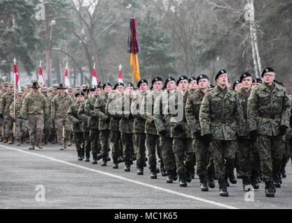 Polish Soldiers from 10th Armored Cavalry Brigade and U.S. Soldiers from 5th Squadron, 4th Regiment, 2nd Armored Brigade Combat Team, 1st Infantry Division, march in formation during a farewell ceremony hosted by 10th ACB in Swietoszow, Poland, Jan. 22, held to bid farewell to the squadron, as they transition their operations to Grafenwoehr, Germany for scheduled training. (Polish Land Forces photo by Pvt. Natalia Wawrzyniak) Stock Photo