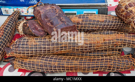 Various products from dried meat exposed to view and tasting before sale. Stock Photo