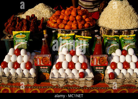 Street food Stall different spicy snacks and noodles with eggs and tomatoes masala powders for attracting customers business tactics Odisha India Stock Photo