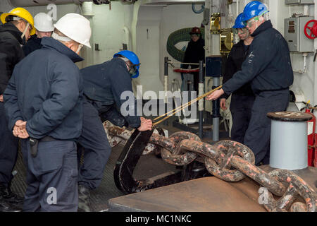 USS Bonhomme Richard (LHD-6) was a Wasp-class amphibious assault ship serving with the United States Pacific Fleet. On January 23, 2018, sailors positioned a pelican hook onto an anchor chain in the forecastle while operating from Sasebo, Japan. The archival image documents detailed seamanship procedures aboard the forward-deployed amphibious assault ship. Stock Photo