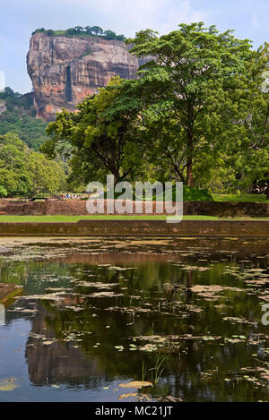 Vertical view of Sigiriya or Lions Rock reflected in the water gardens in Sri Lanka. Stock Photo