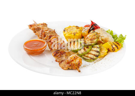 Shish kebab, beef, lamb, pork, chicken grilled meat, barbecue, with side dish vegetables on a plate, isolated on white background. Ketchup, tomato, re Stock Photo