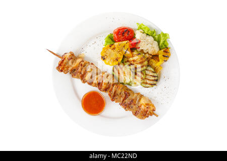 Shish kebab, beef, lamb, pork, chicken grilled meat, barbecue, with side dish vegetables, isolated on white background. Ketchup, tomato, red sauce. Vi Stock Photo