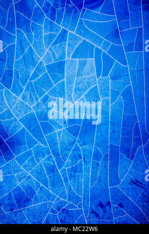 Dirty, damaged blue foil on window, background. Stock Photo