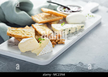 Small cheeseboard with baguette Stock Photo