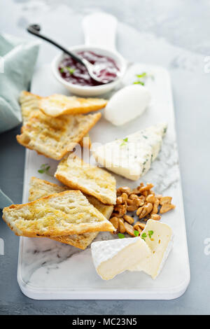 Small cheeseboard with baguette Stock Photo