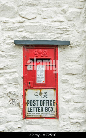 George V Red Wall Mounted Letterbox in Laugharne, Carmarthenshire, South Wales Stock Photo