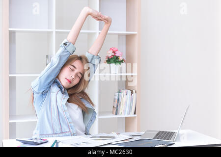 Asian young business women stretching hands in office after finish her work Stock Photo