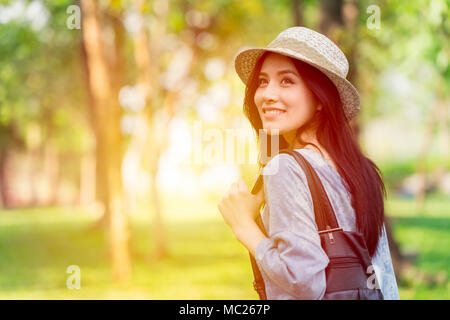 Freedom and Finding Concept: Casual cute smart Asian women walking in the park in summer for holiday relax Stock Photo