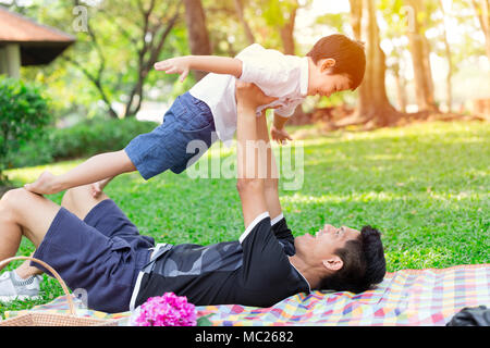 Good Daddy and Son playing together in park concept Stock Photo