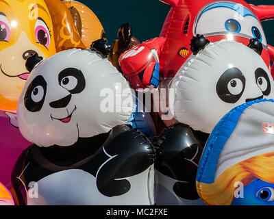 Balloons with shape of cartoon characters on sale at concert of band for children with Jett of Super Wings, Smurfette of The Smurfs and others Stock Photo