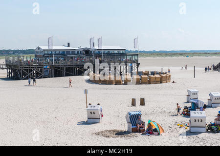 Holiday makers sitting in their beach chairs enying the sunshine, St. Peter-Ording, Nordfriesland, Schleswig-Holstein, Germany, Europe Stock Photo