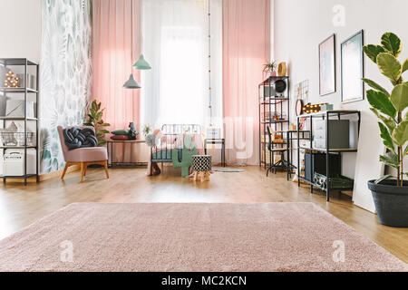 Bright, spacious teenage girl room interior with metal bed, pink drapes and soft carpet on the floor Stock Photo